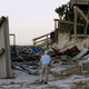 H.V. Bailey looks at damage to a neighbor’s home at Ponte Vedra Beach, Fla., Saturday, Oct. 8, 2016, after Hurricane Matthew passed through Friday. (Image: AP)